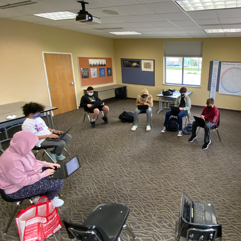 Students in a circle having class.