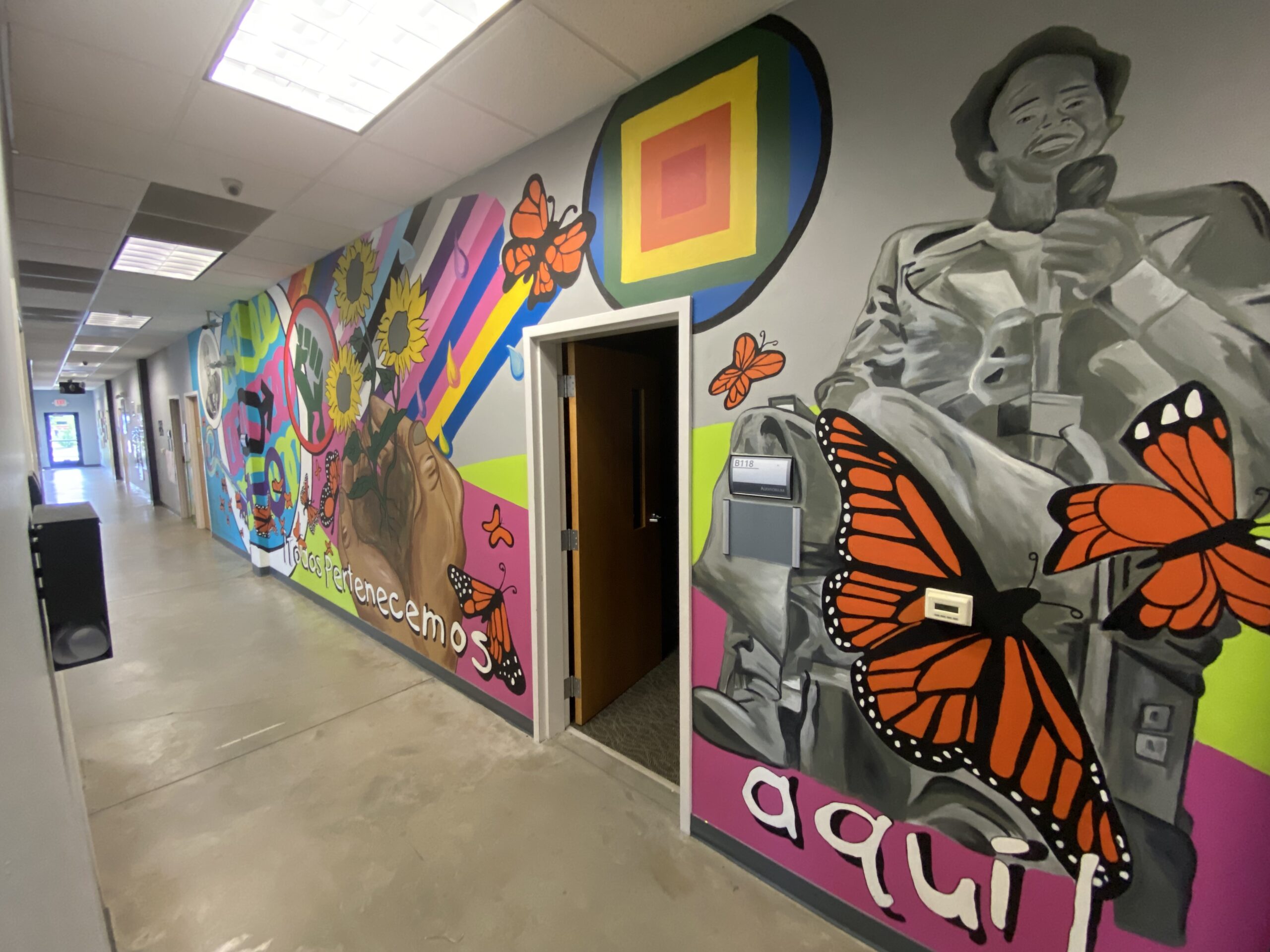 School hallway with brightly colored mural.
